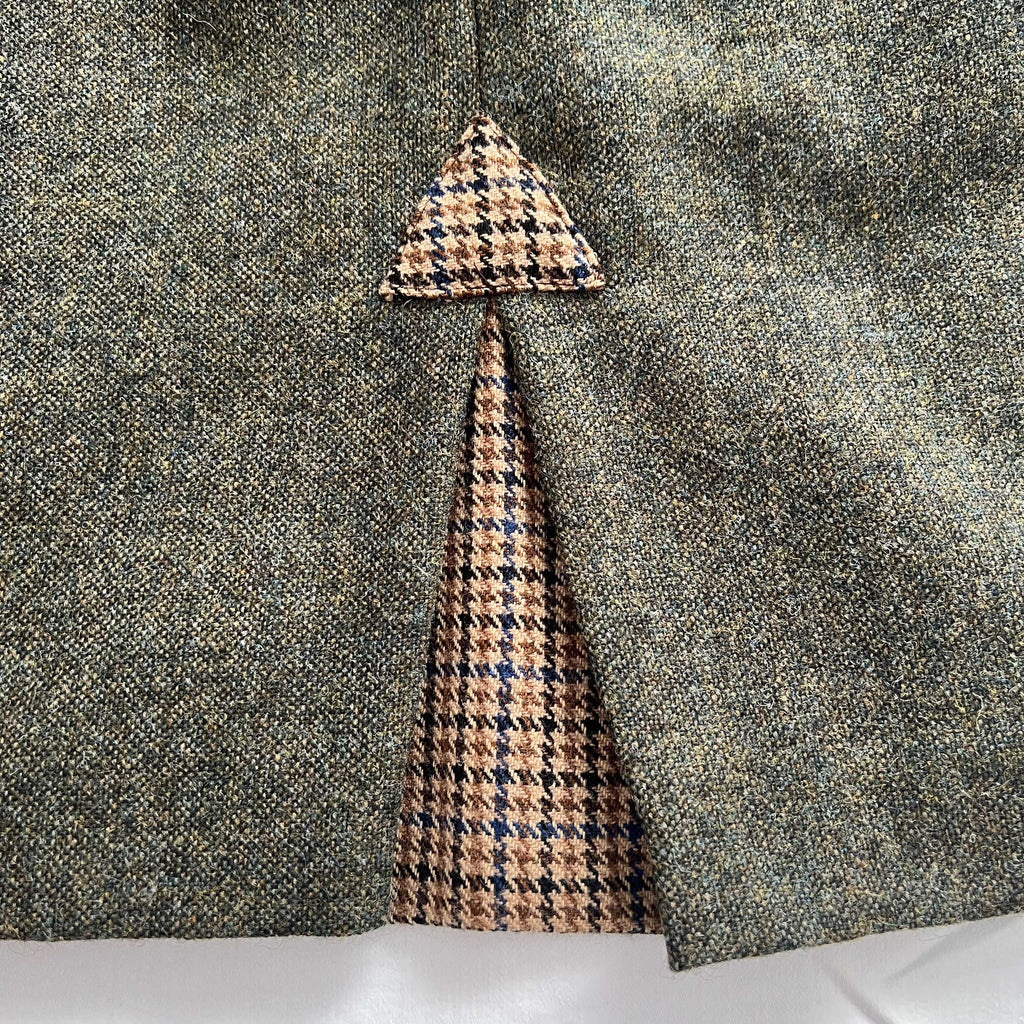 Rear pleat detail of the Adderbury knee length tweed skirt in Village Green