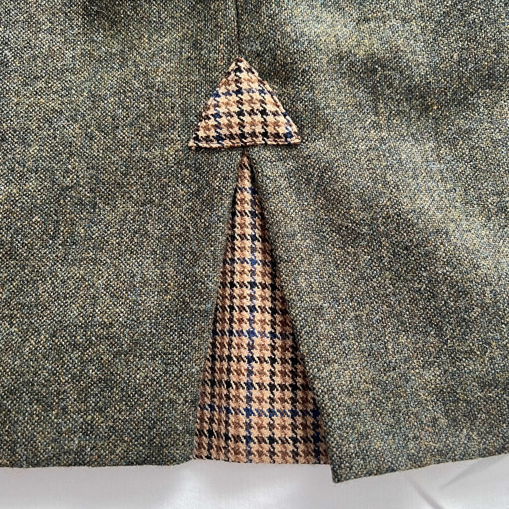 Rear pleat detail of the Adderbury knee length tweed skirt in Village Green