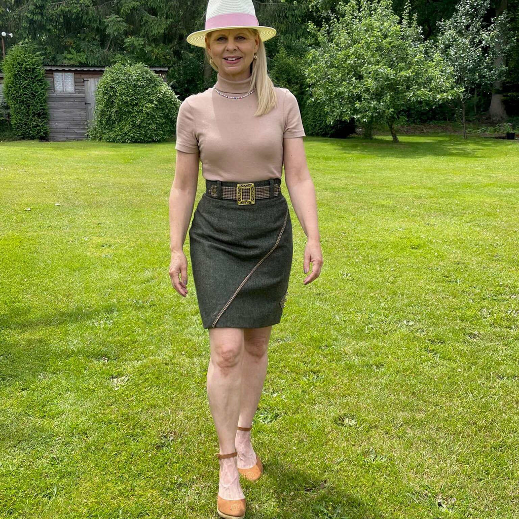 Lifestyle image of the Adderbury tweed knee length skirt styled with neutral colours for summer