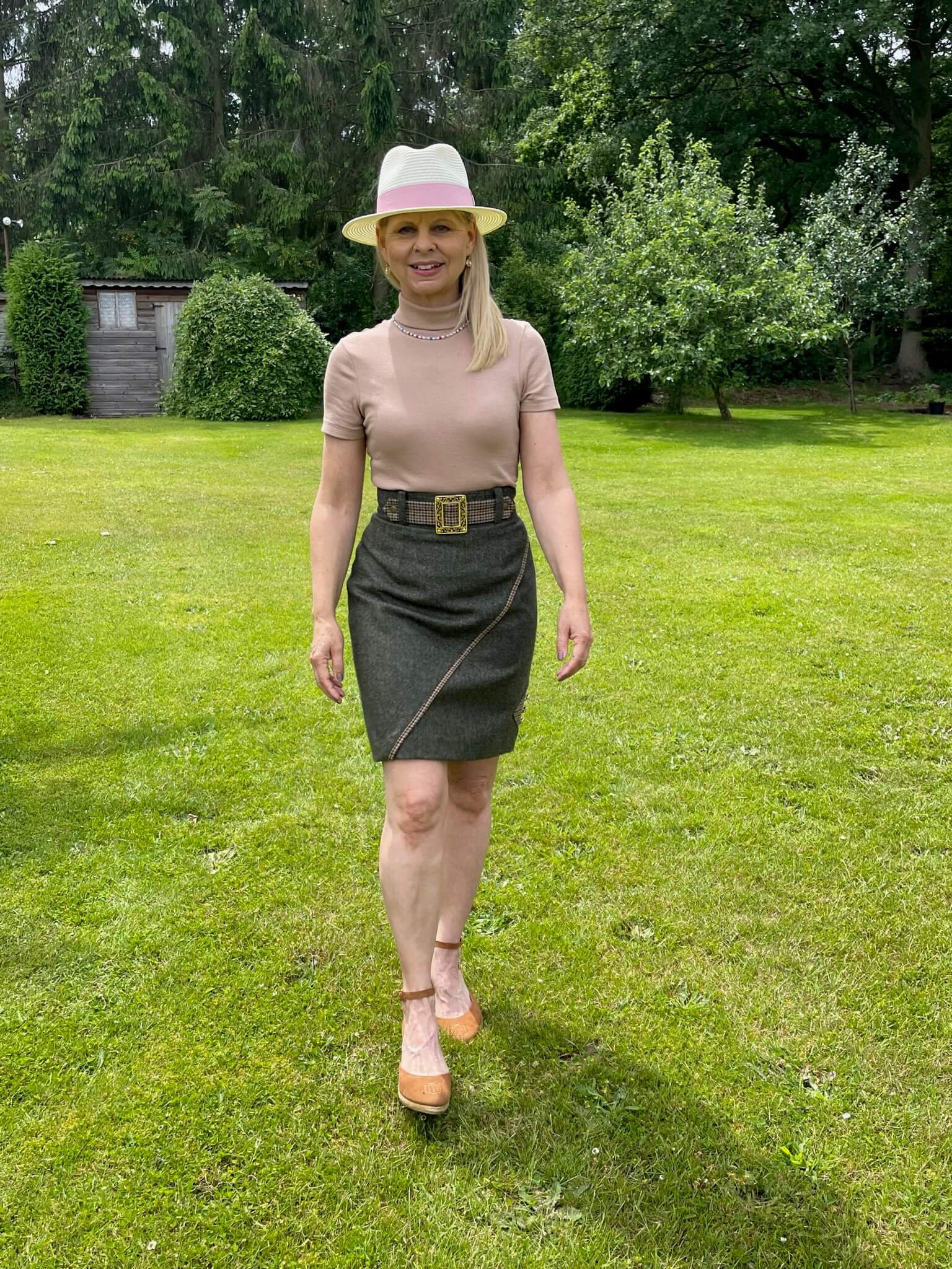Lifestyle image of the Adderbury tweed knee length skirt styled with neutral colours for summer