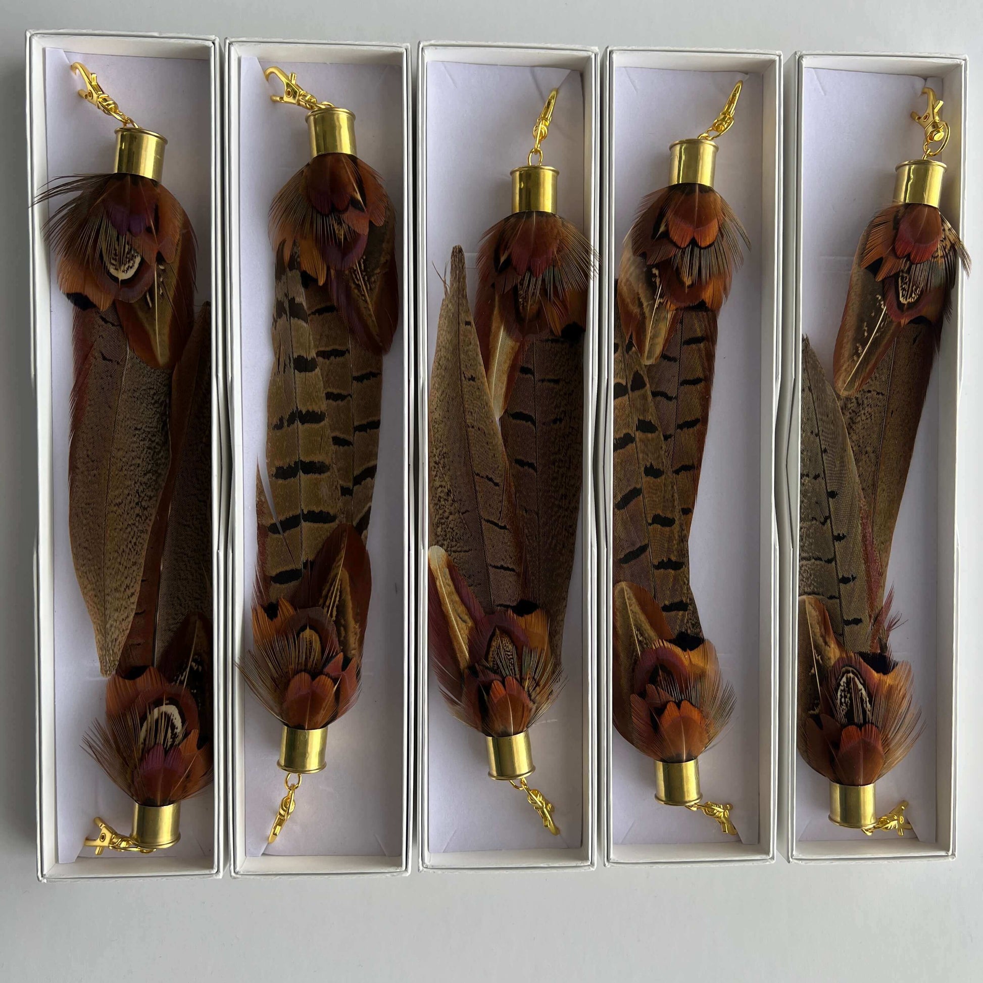 selection of long brown feather boot tassels in gift boxes