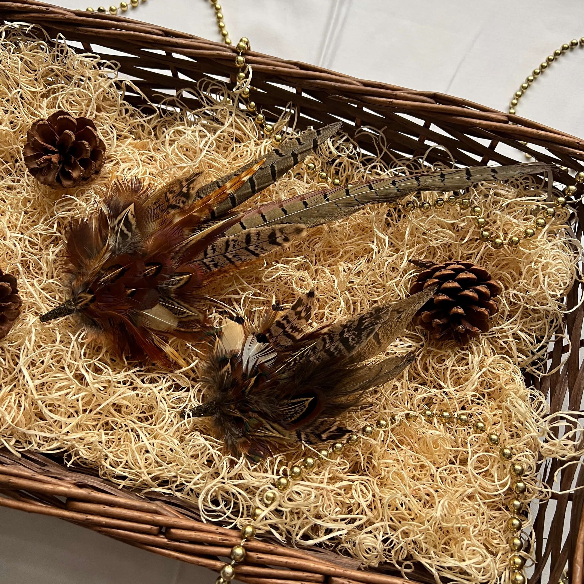 Christmas hamper basket with a feather hat pin and brooch pin