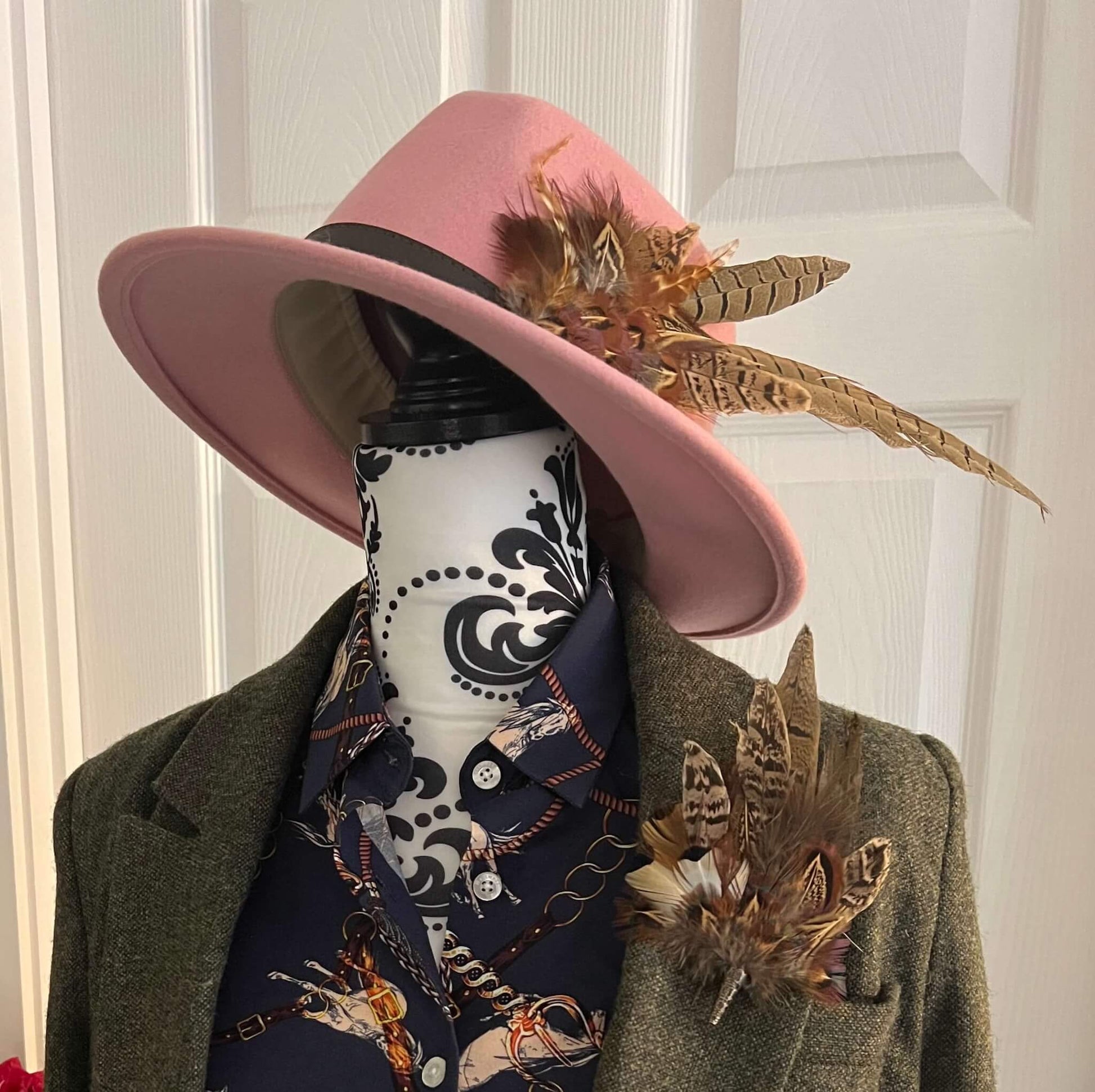 country outfit featuring feather hat pin and tweed jacket