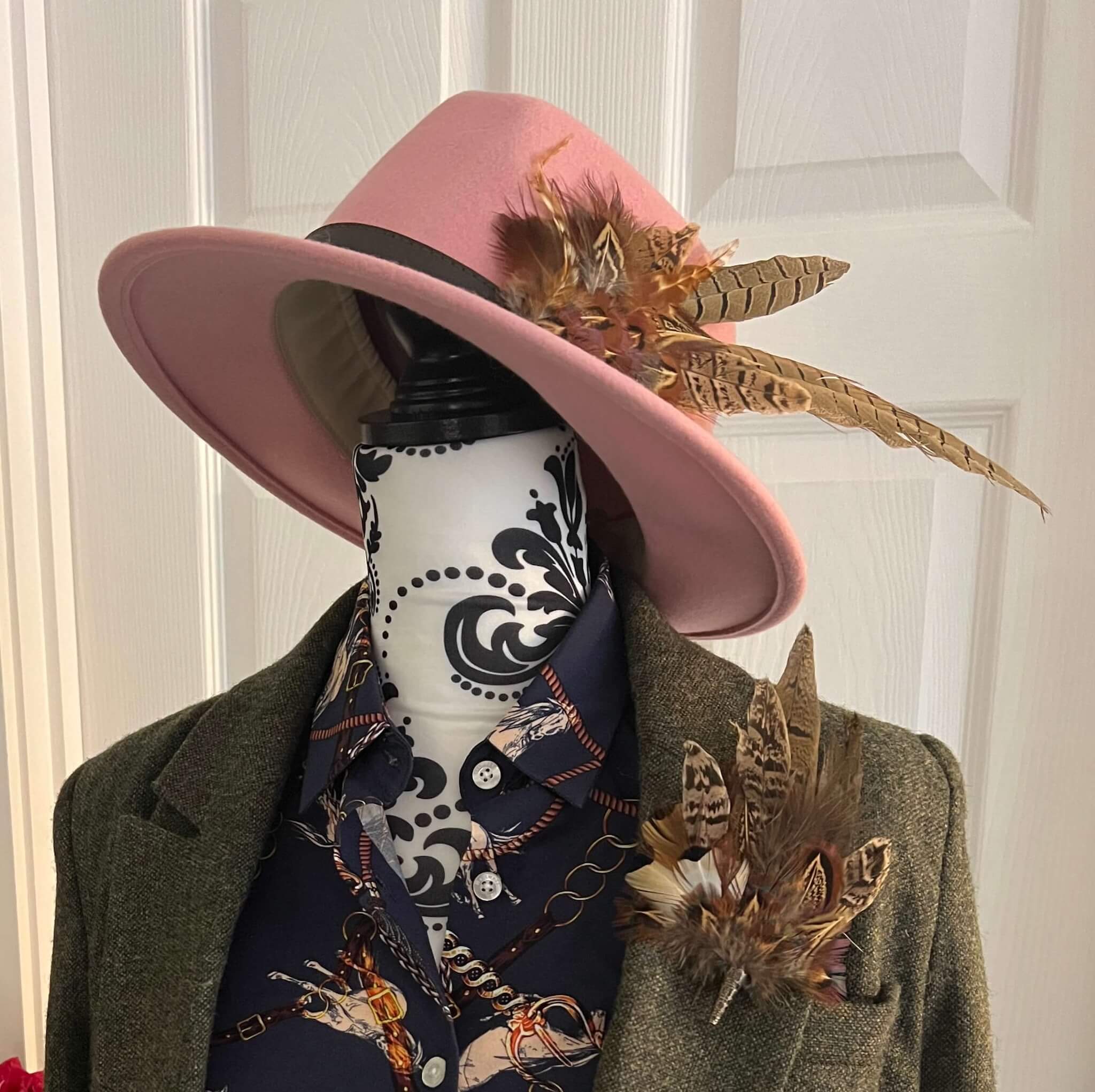 country outfit featuring feather hat pin and tweed jacket