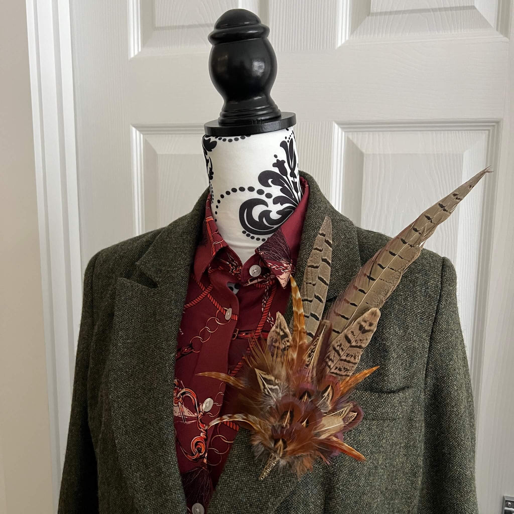 country outfit featuring large feather pin and tweed jacket