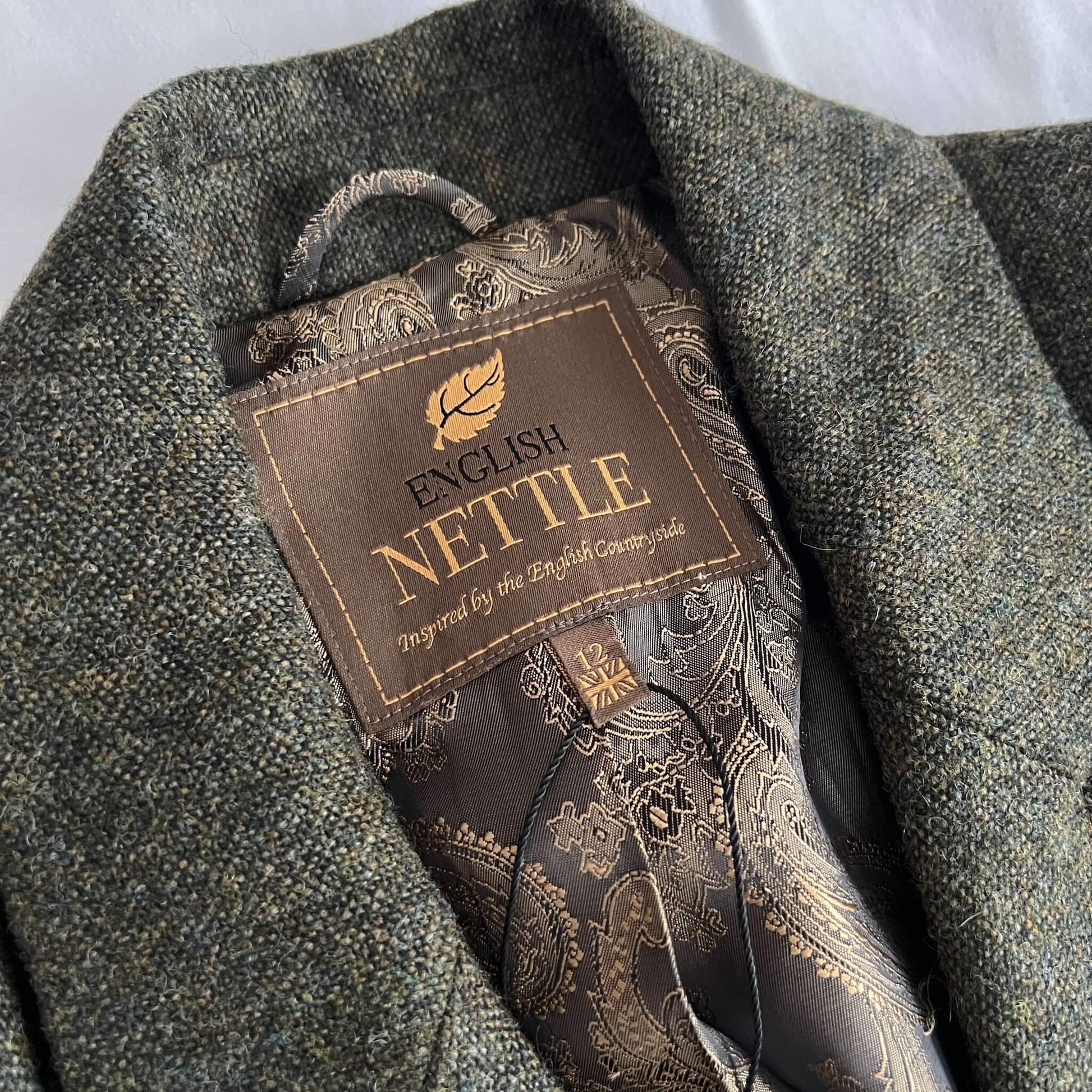 close up of inside collar detail of green tweed jacket