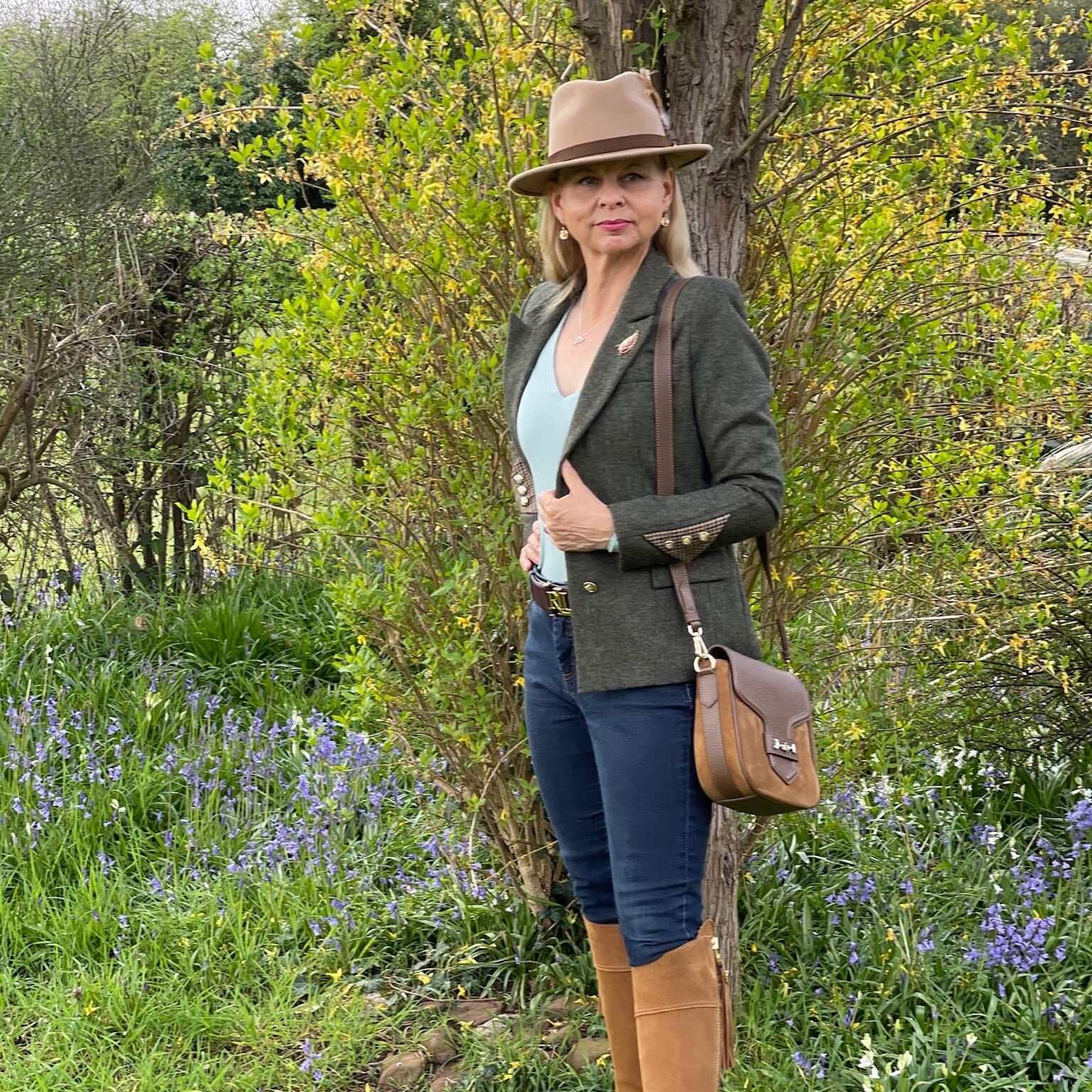 Heyford green tweed jacket by English Nettle styled with blue jeans and tan boots