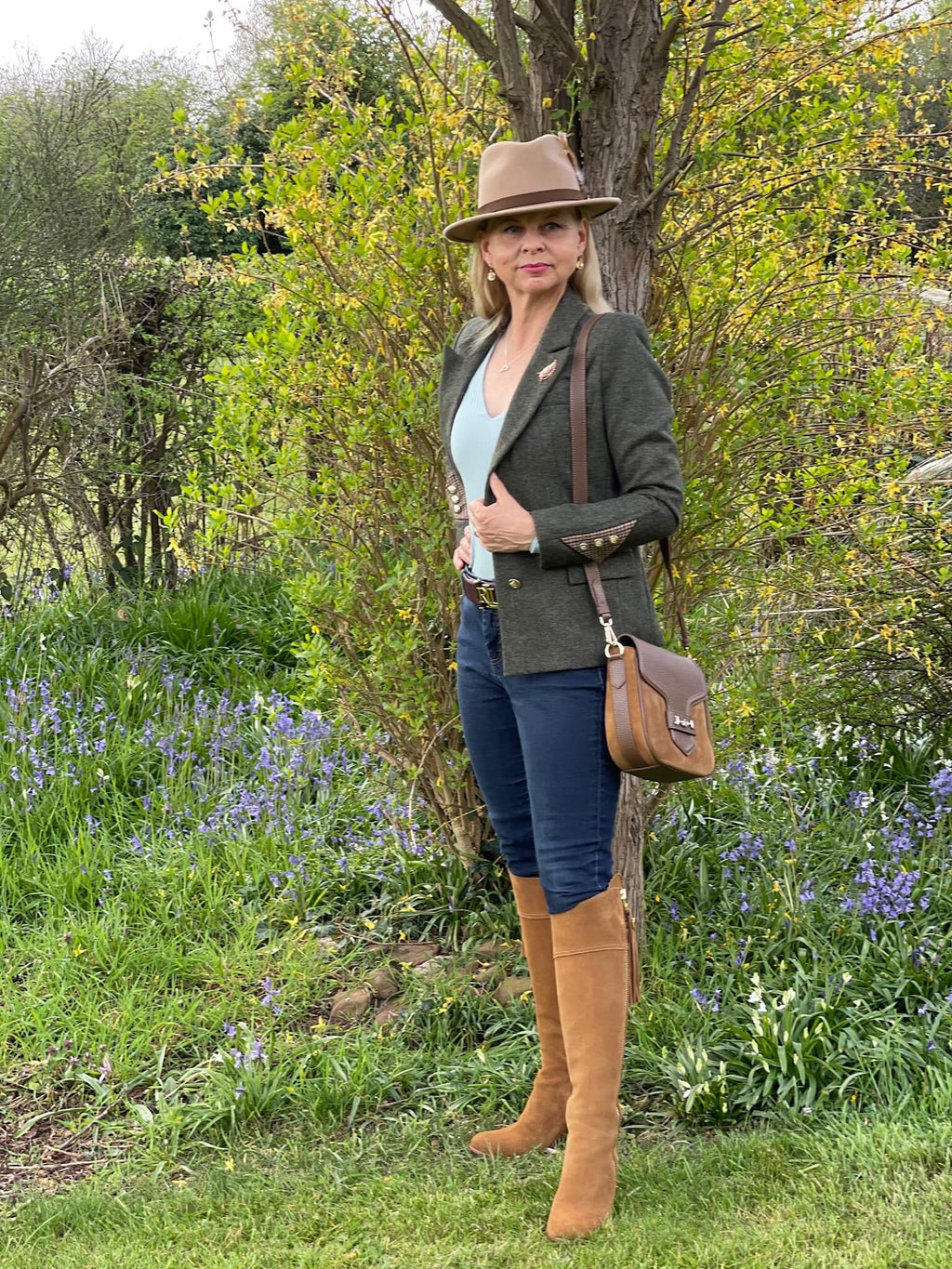 Heyford green tweed jacket by English Nettle styled with blue jeans and tan boots