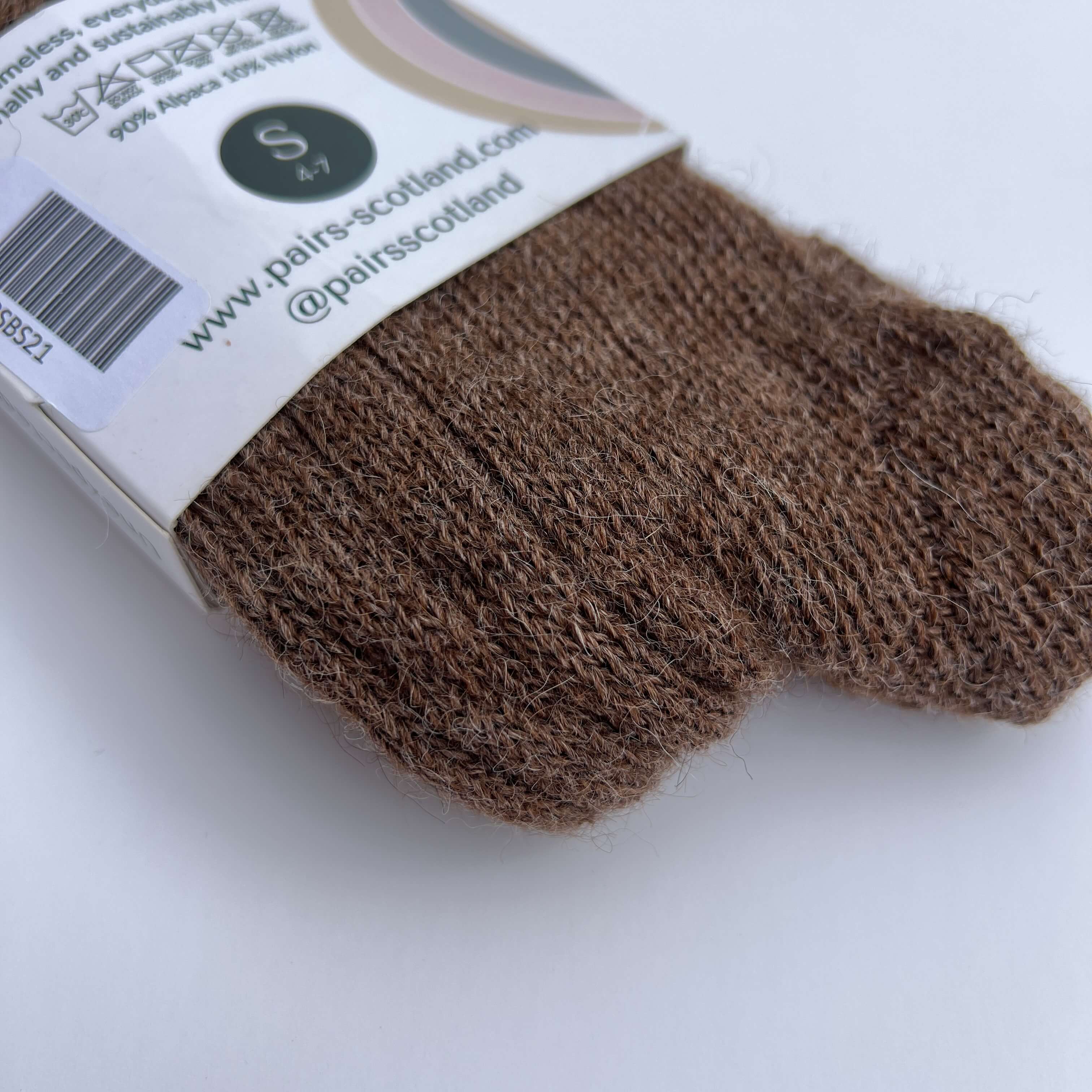 Brown Pairs alpaca bed socks with a label