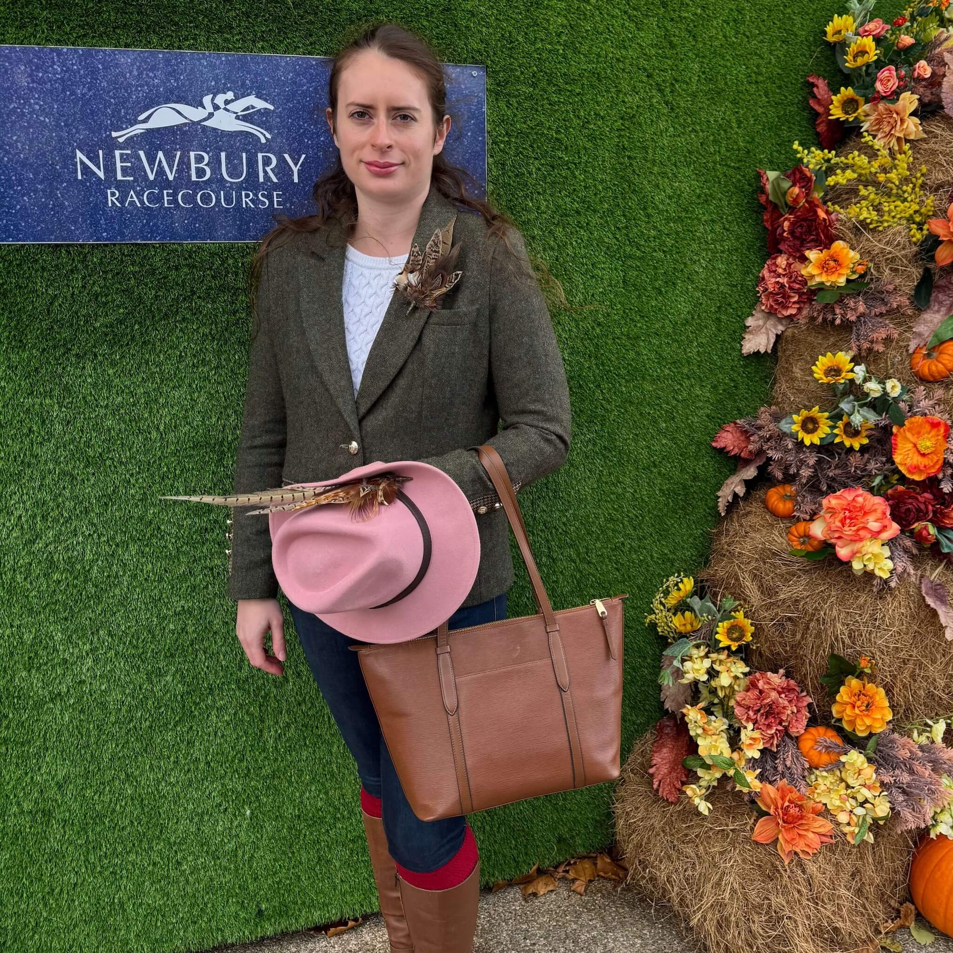 racing outfit featuring green tweed jacket and feather hat pin