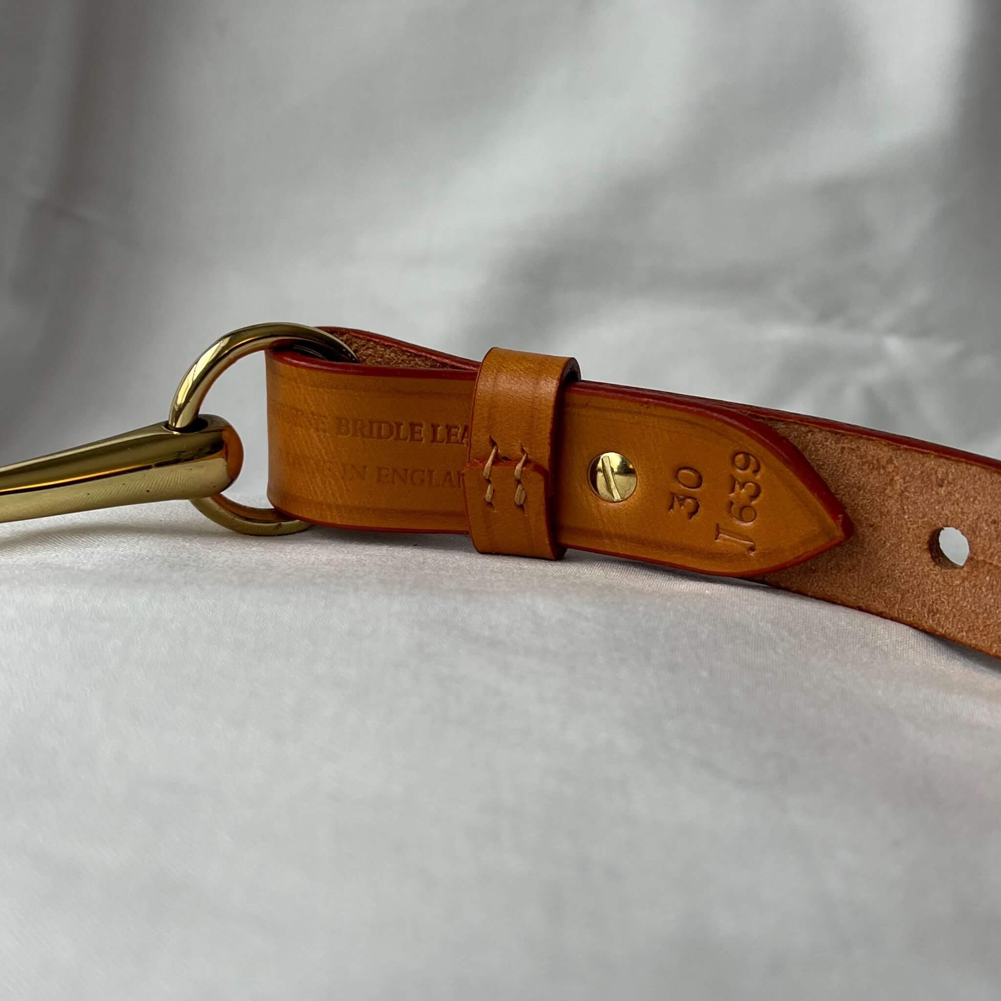 tan equestrian belt handmade in the uk with farm traced English leather showing authentication detail