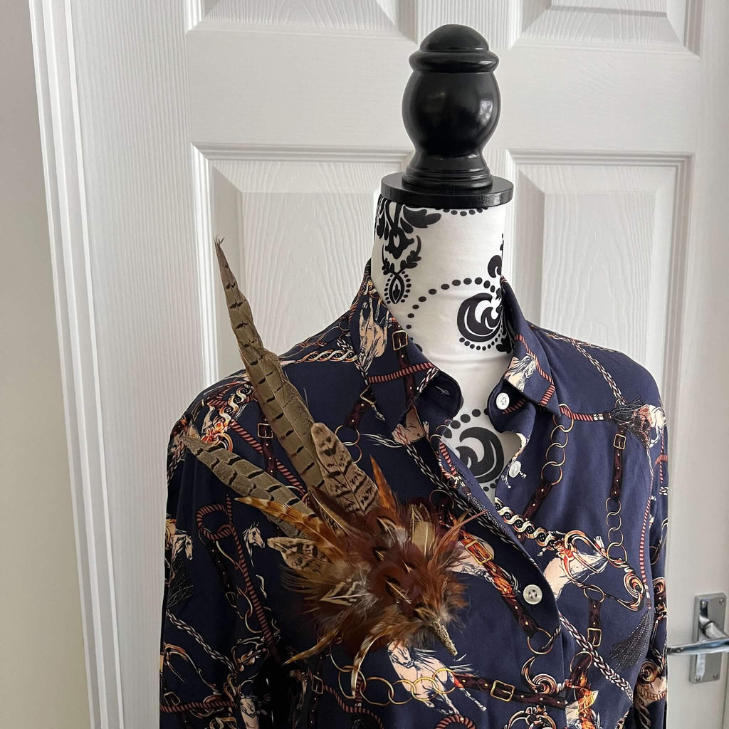 country outfit featuring large feather hat pin