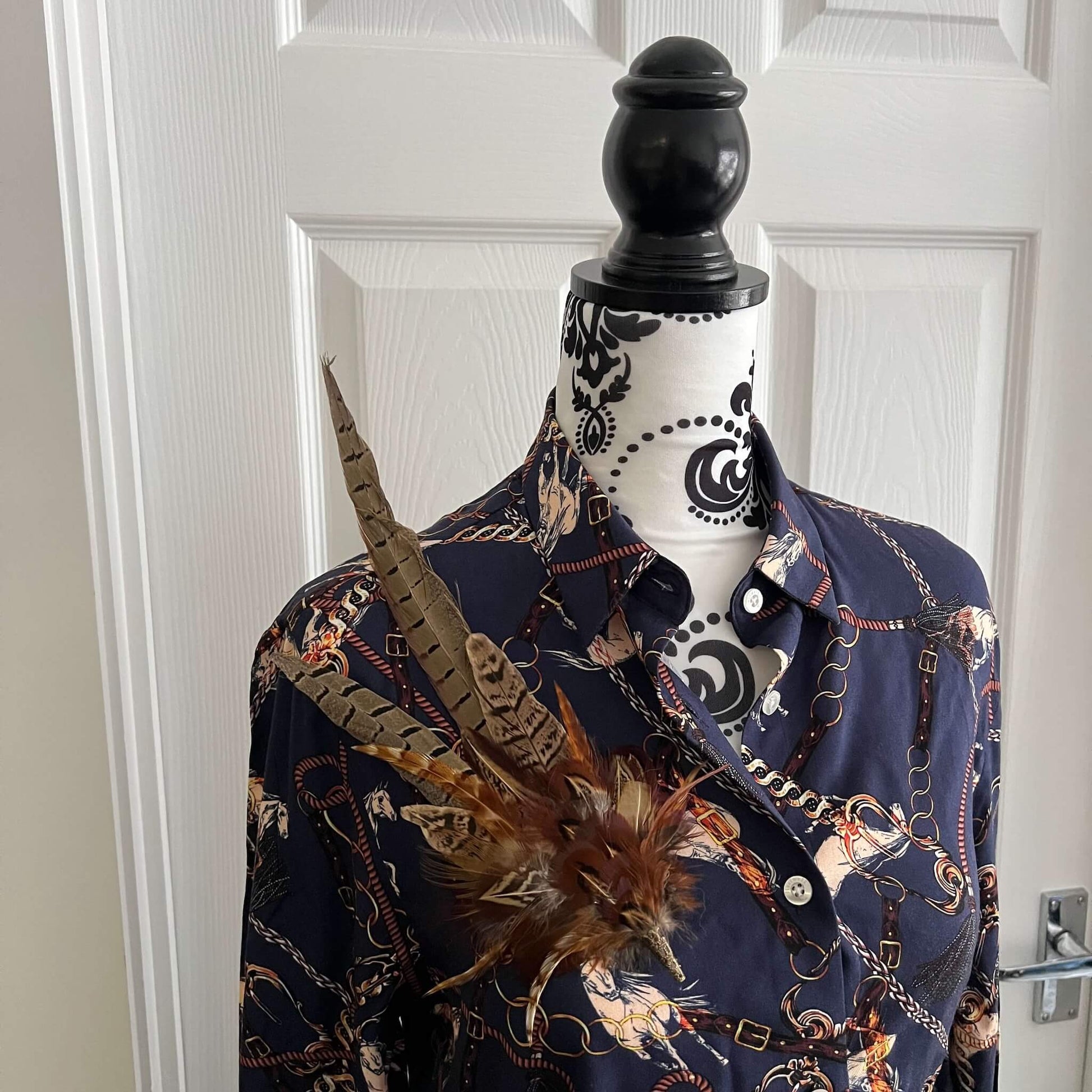 country outfit featuring large feather hat pin