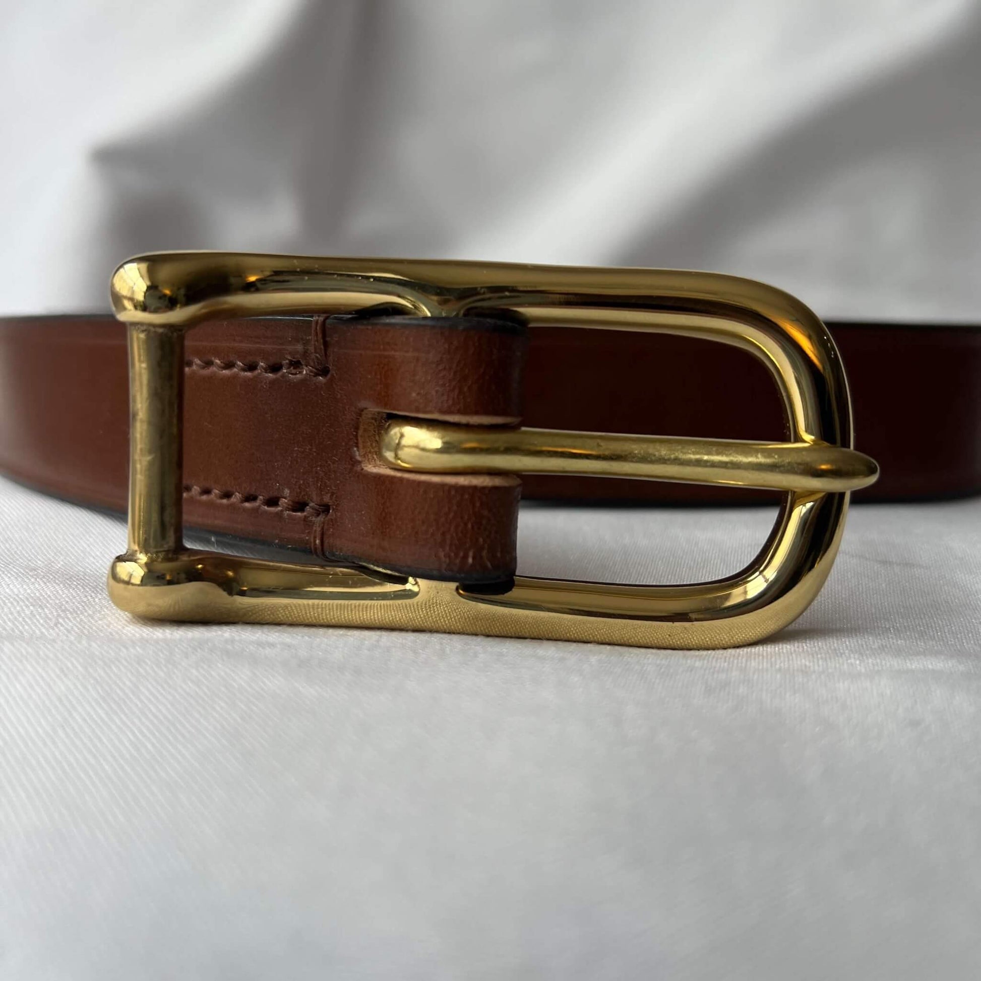 close up of ladies' skinny leather belt showing solid sand cast brass buckle