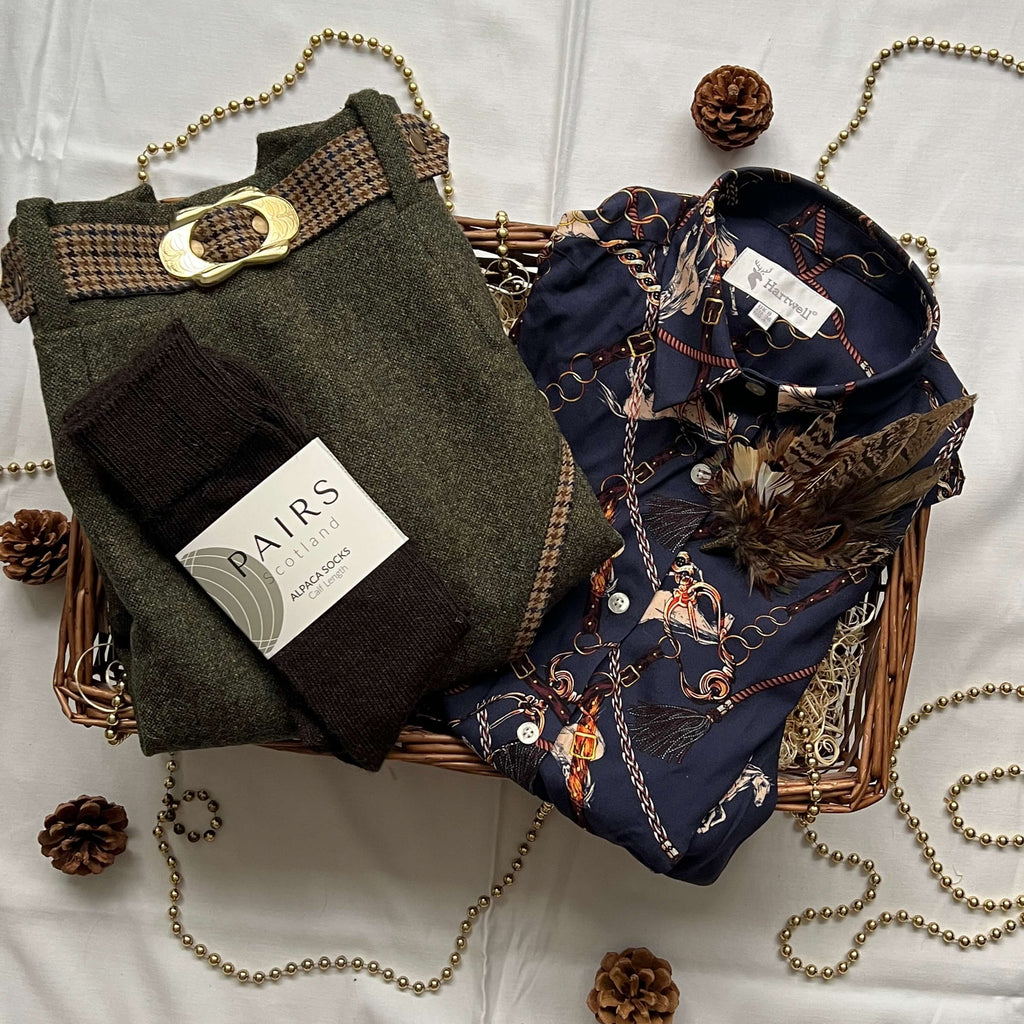 Christmas hamper basket with green tweed skirt, blue equestrian shirt, alpaca wool socks and feather brooch pin