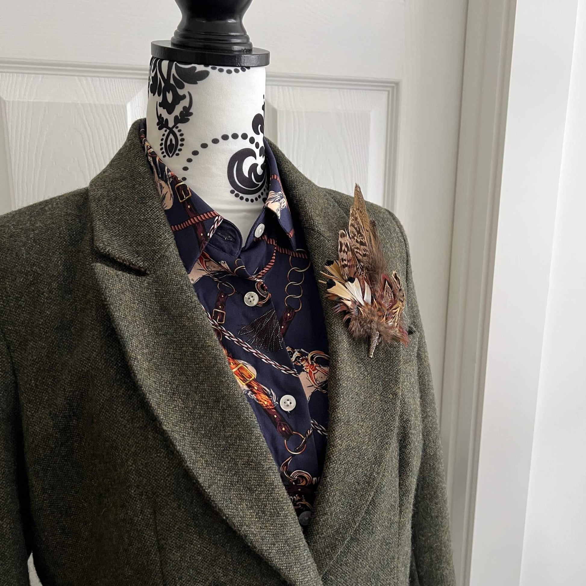 country outfit featuring tweed jacket and feather brooch pin